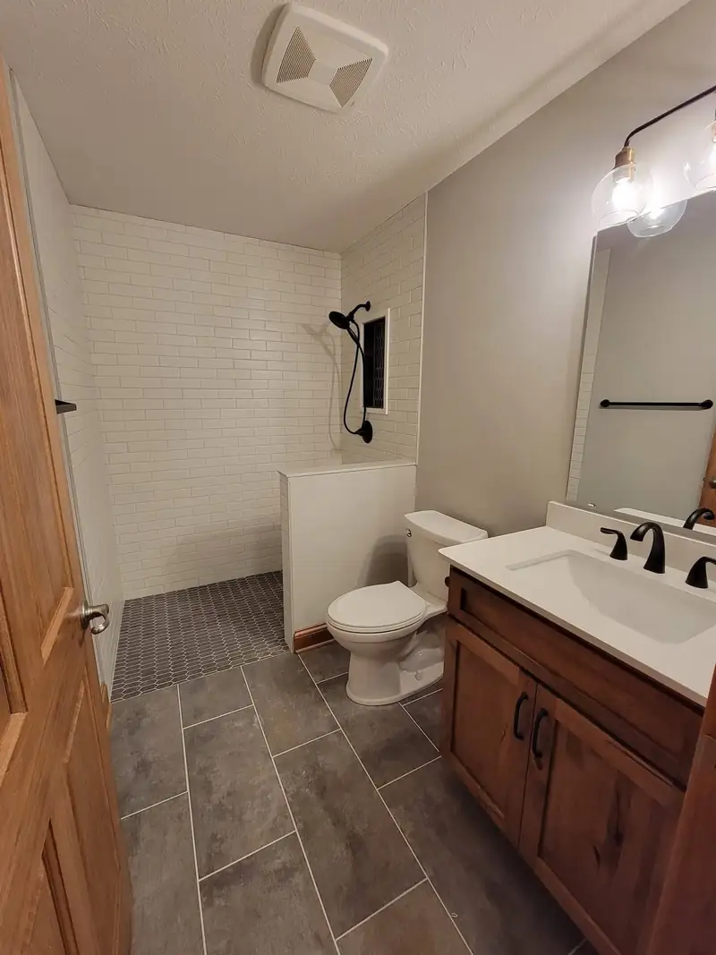 Accessible full bathroom with a low-threshold shower and a wall-mounted grab bar
