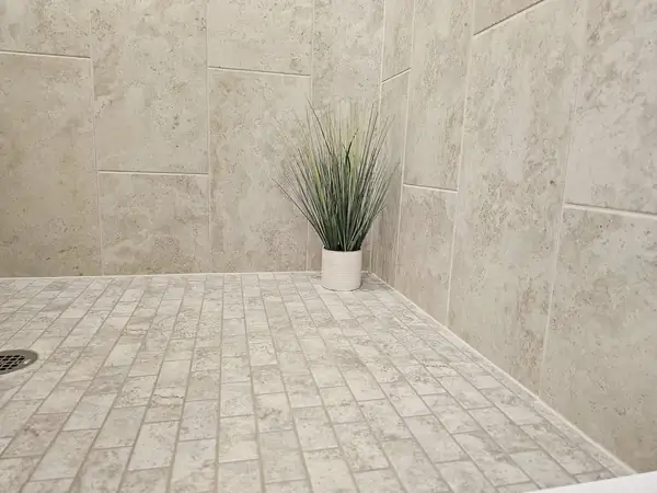 Large format tile shower with a textured floor