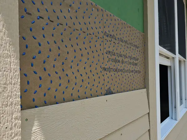 Weather barrier and flashing detail behind new siding
