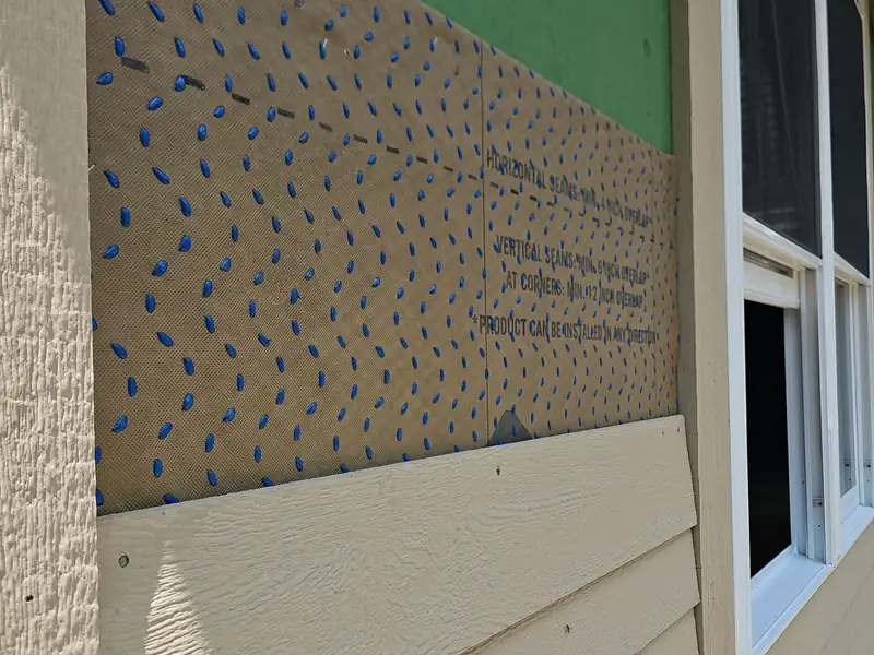 Weather barrier and flashing detail behind new siding on a Northwood Homes build