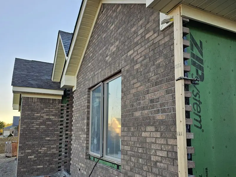 Brick veneer going up over taped ZIP System sheathing on a Northwood Homes build