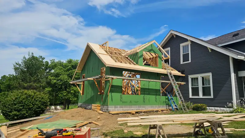 Crew framing a room addition onto an existing Boone County home