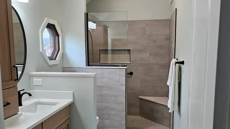 Zero-entry tiled shower with a built-in bench and grab bar