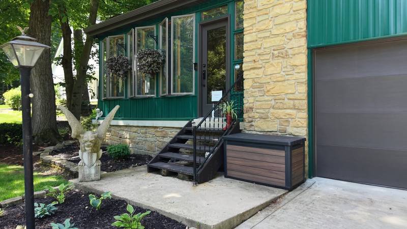 Entry of a completed Northwood Homes project with stone, dark siding and landscaping